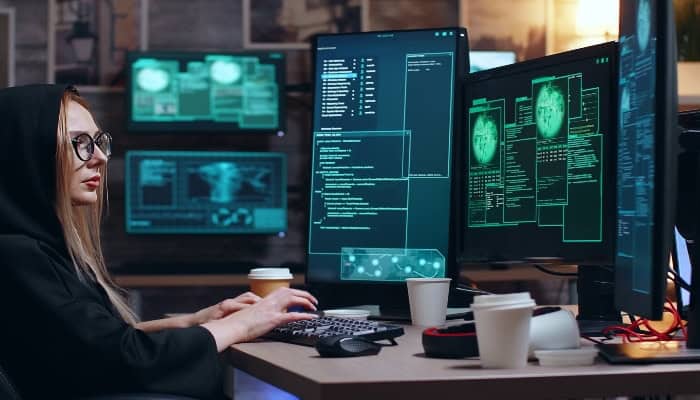 Advanced cybersecurity training at MyComputerCareer with multiple monitors displaying code and security protocols. Perfect for IT professionals seeking career advancement.
