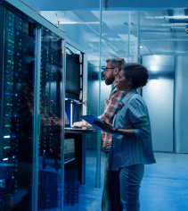 Server room with IT professionals working on network equipment, depicting technical training at MyComputerCareer for IT and cybersecurity careers.