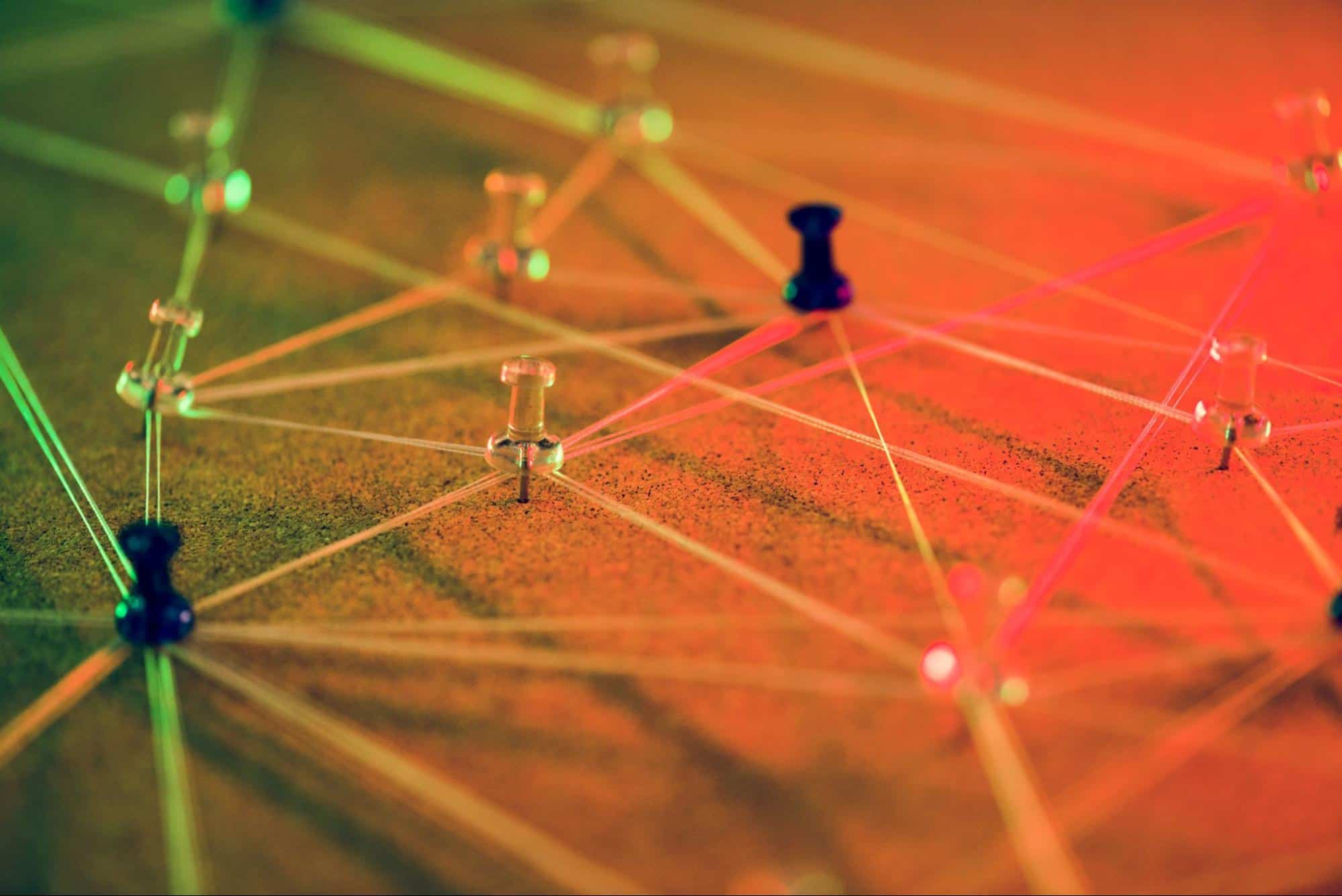 Innovative technology network diagram with colored push pins and illuminated interconnecting lines representing digital connectivity and computer networking concepts.